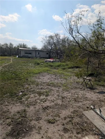 a view of a field with an trees