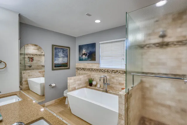 a bathroom with a bathtub and shower