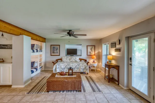 a bedroom with furniture and a large window