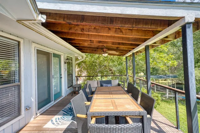 a backyard of a house with table and chairs