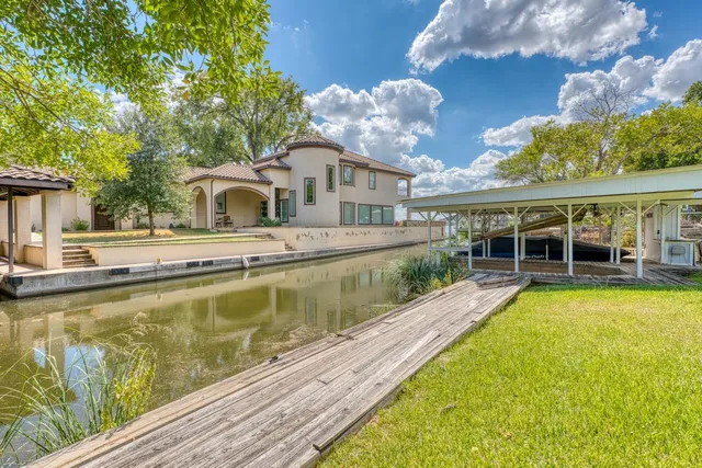 a view of a house with pool and a yard