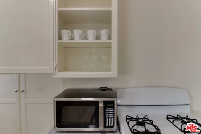 a kitchen with a window a sink and cabinets