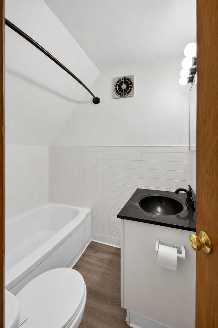 226 West Locust Street DeKalb, IL 60115 - Photo 25 of 40 a bathroom with a sink and a toilet