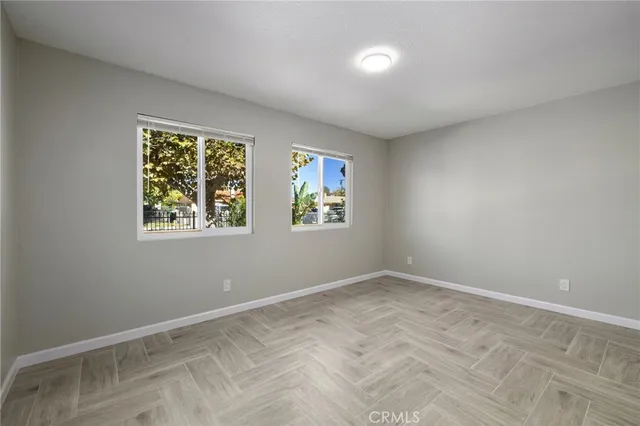 an empty room with windows and closet