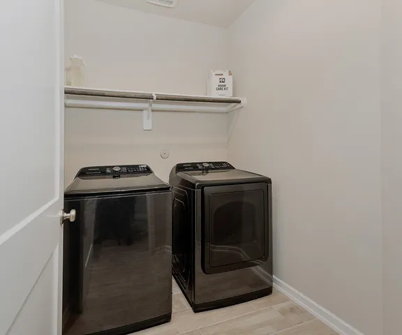 a view of a backyard with table and chairs and wooden fence