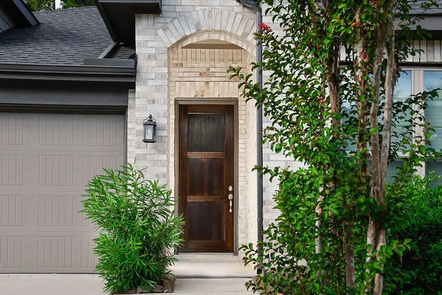 a front view of a house with plants