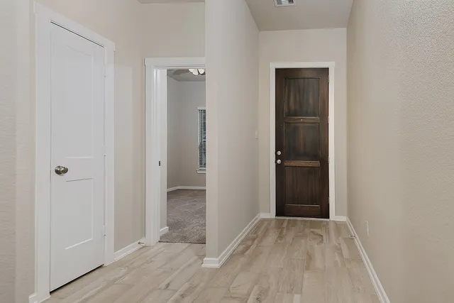 a view of a kitchen from the hallway