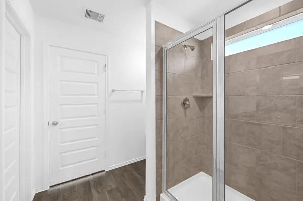 a bathroom with a glass shower door