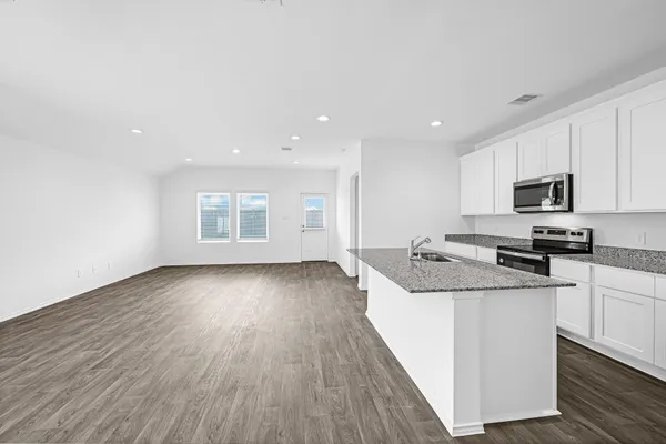 a kitchen with a stove a sink and a refrigerator