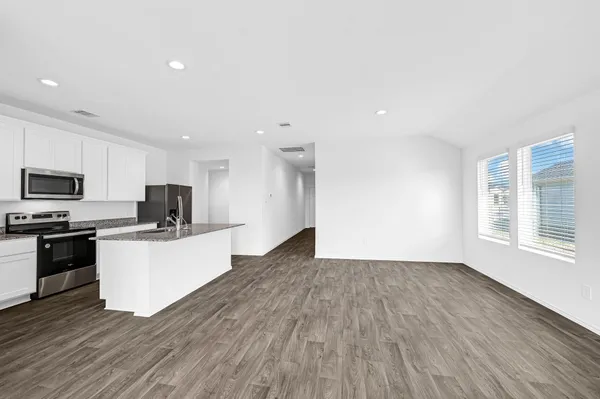 a kitchen with stainless steel appliances a refrigerator sink and microwave