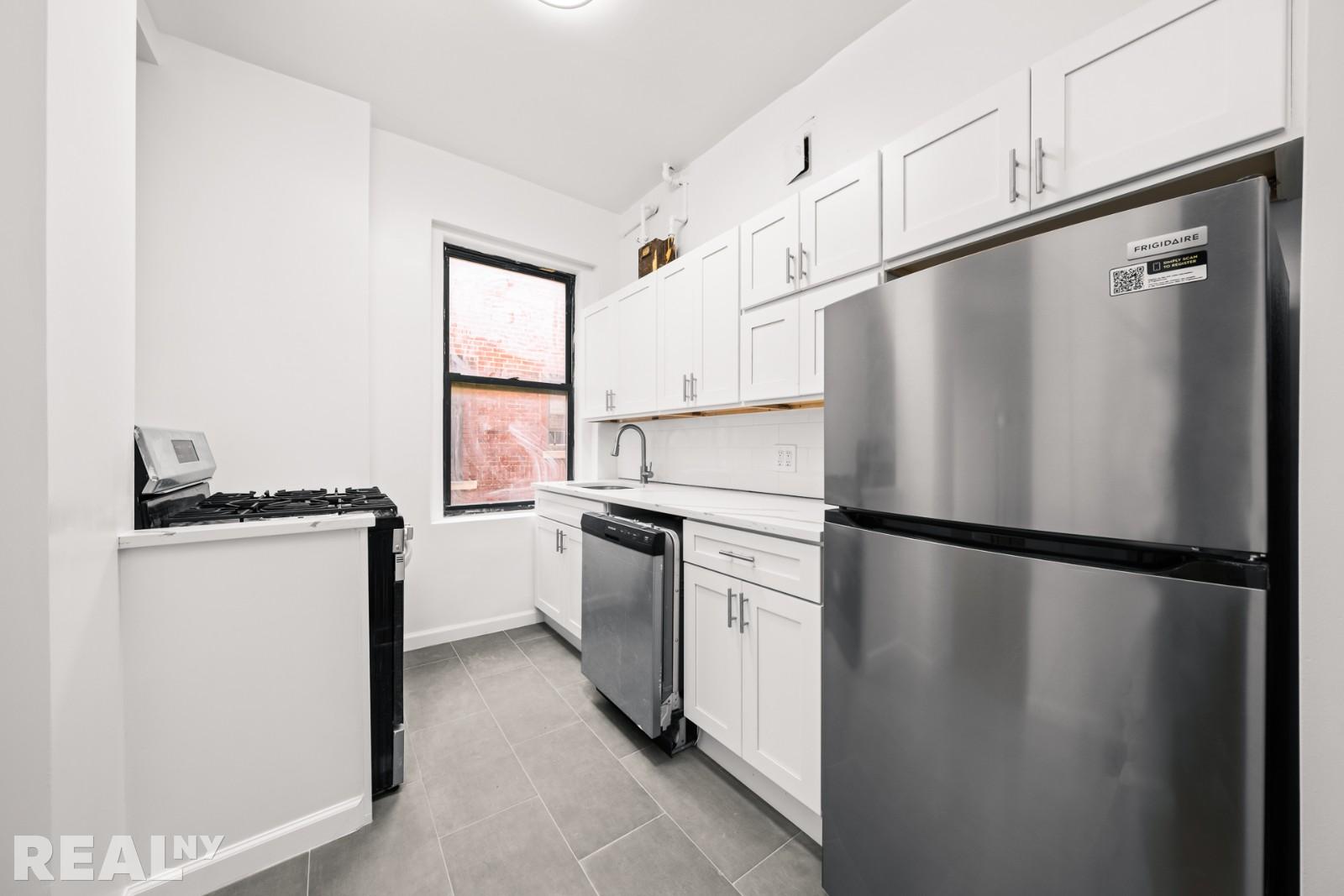 690 Riverside Drive, Unit 6D Manhattan, NY 10031 - Photo 5 of 7 a kitchen with a refrigerator and a stove top oven