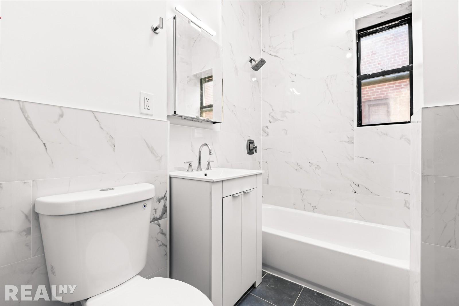 690 Riverside Drive, Unit 6D Manhattan, NY 10031 - Photo 6 of 7 a bathroom with a sink a toilet and shower