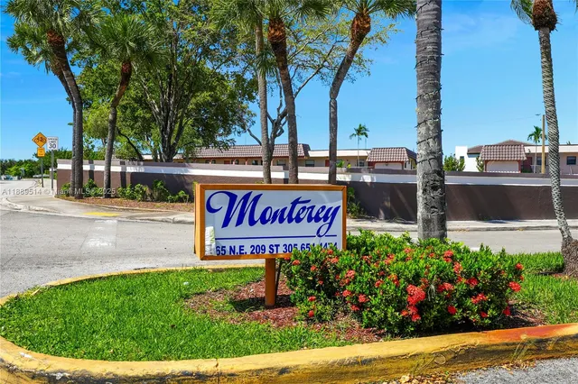 a sign that is sitting in the middle of a park