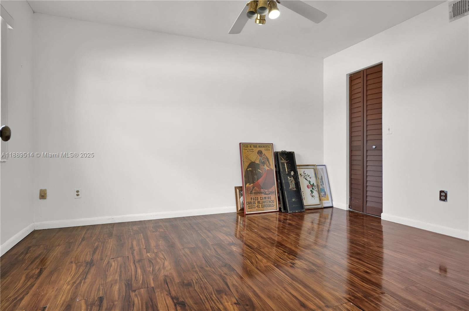 860 Northeast 207th Terrace, Unit 8106 Miami, FL 33179 - Photo 13 of 24 a view of empty room with wooden floor