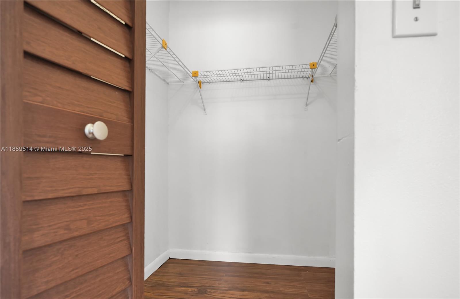 860 Northeast 207th Terrace, Unit 8106 Miami, FL 33179 - Photo 16 of 24 a view of walk in closet with empty racks