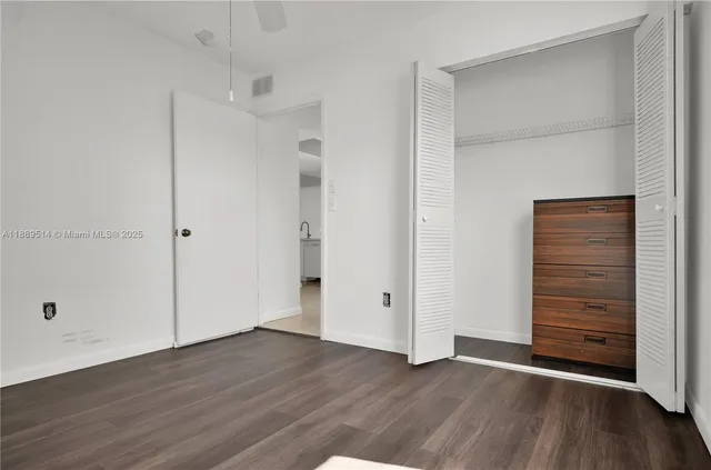 an empty room with wooden floor