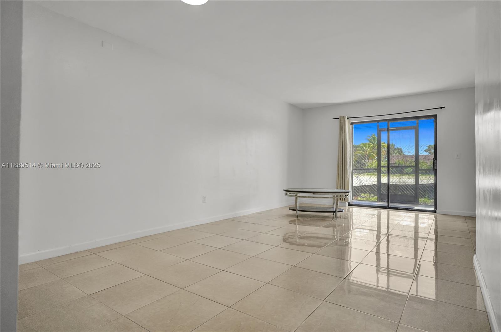 860 Northeast 207th Terrace, Unit 8106 Miami, FL 33179 - Photo 5 of 24 an empty room with floor to ceiling window