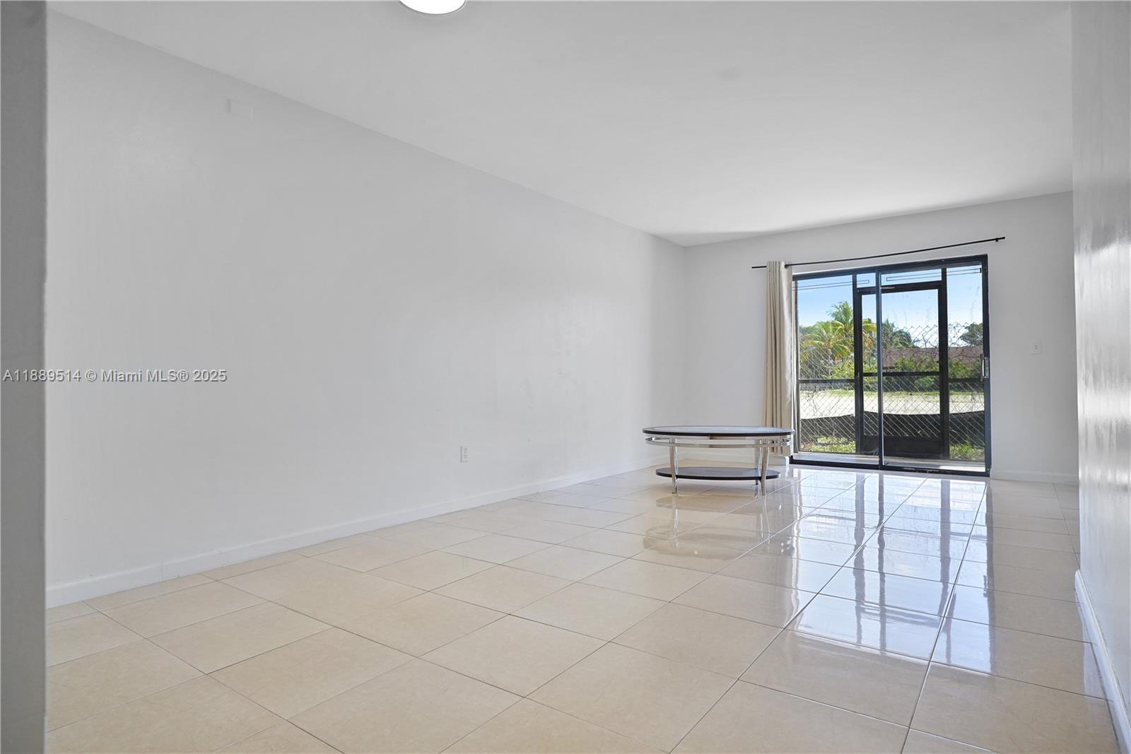 860 Northeast 207th Terrace, Unit 8106 Miami, FL 33179 - Photo 6 of 24 an empty room with windows