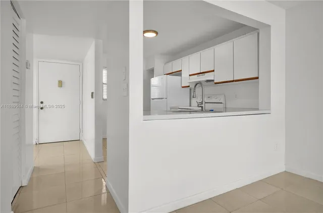 a view of a kitchen with white cabinets