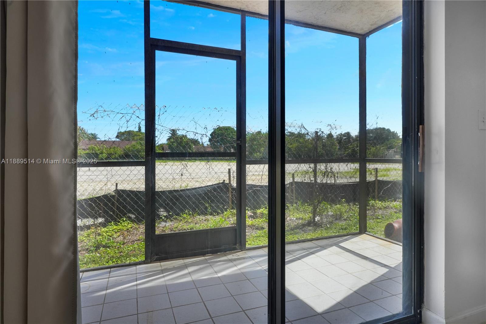 860 Northeast 207th Terrace, Unit 8106 Miami, FL 33179 - Photo 9 of 24 a view of a glass door with a from a window