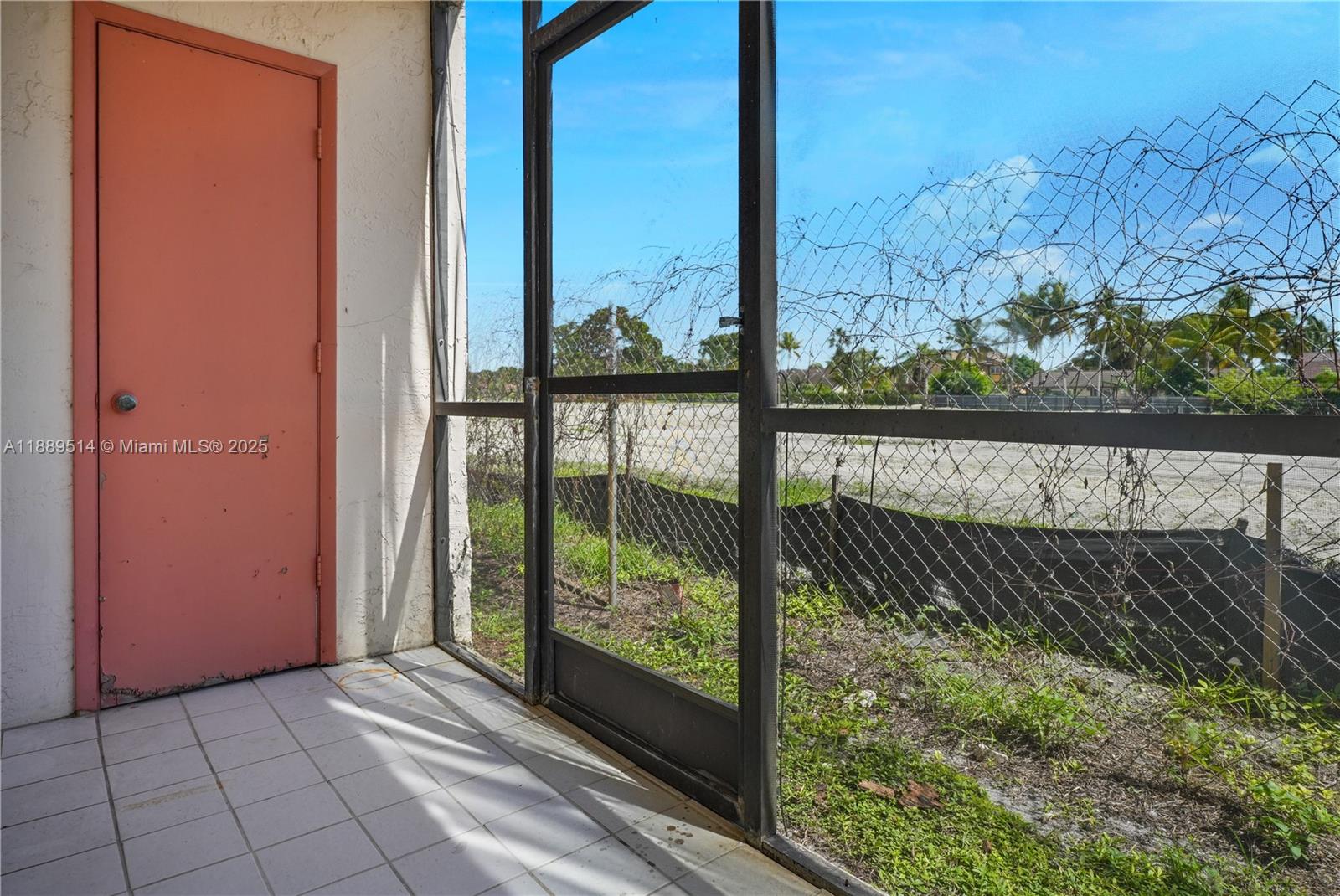 860 Northeast 207th Terrace, Unit 8106 Miami, FL 33179 - Photo 10 of 24 a view of a back yard from a window