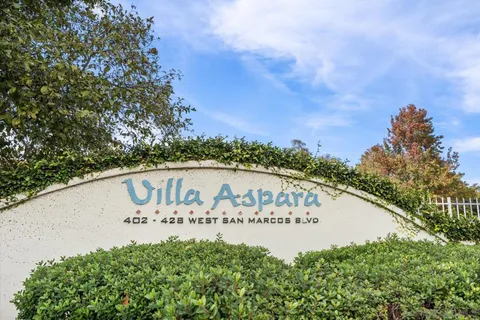 a view of a park with plants and bench