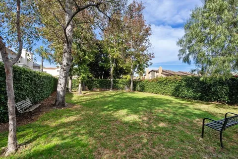 a view of a white house with a street