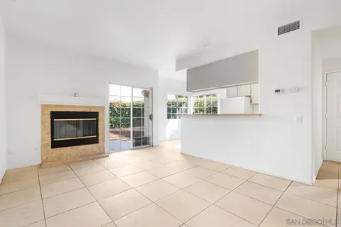 a view of a livingroom with an empty space and a fireplace