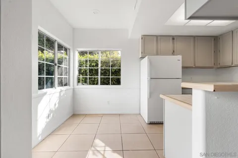 a kitchen with a refrigerator and a stove