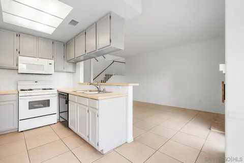 a kitchen with a stove sink and cabinets