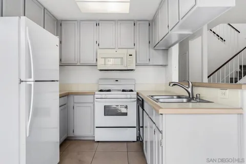 a kitchen with a sink stove and refrigerator