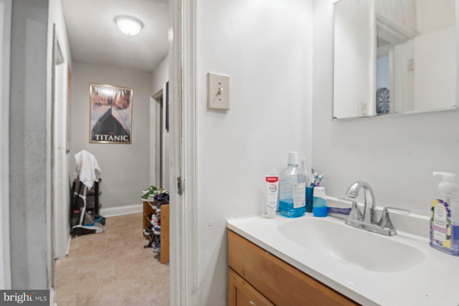 4931 Brookwood Road Baltimore, MD 21225 - Photo 15 of 25 a bathroom with a sink and a mirror