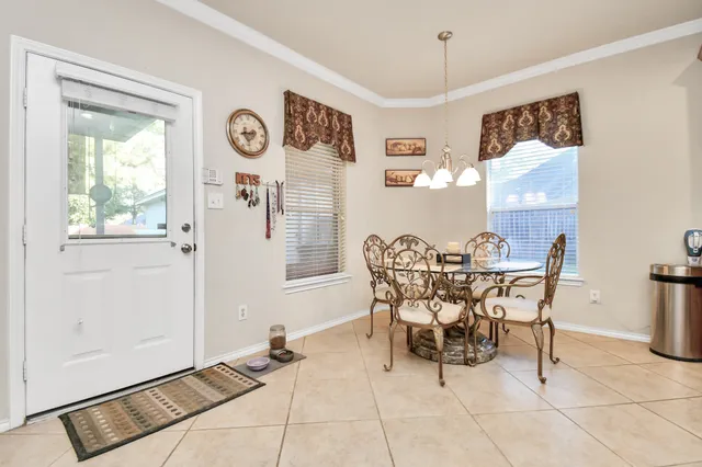 a view of a dining room with furniture and a chandelier