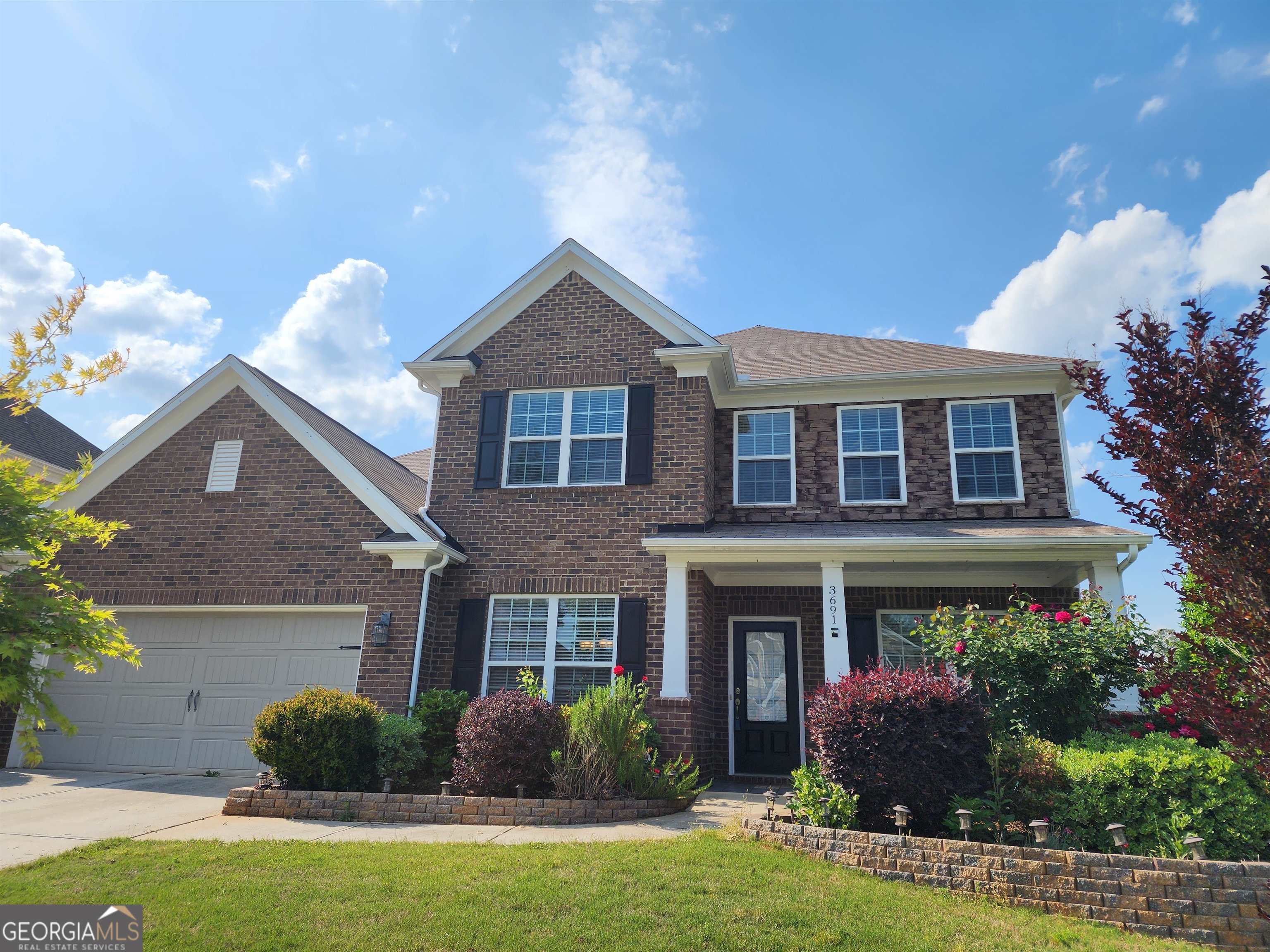 3691 Graham Way Southwest Lilburn, GA 30047 - Photo 1 of 1 a front view of a house with garden