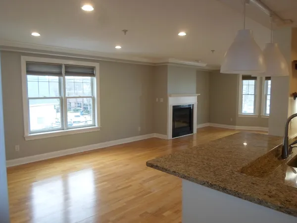 an empty room with a kitchen and a window