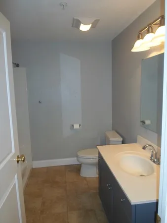 a bathroom with a sink toilet and vanity