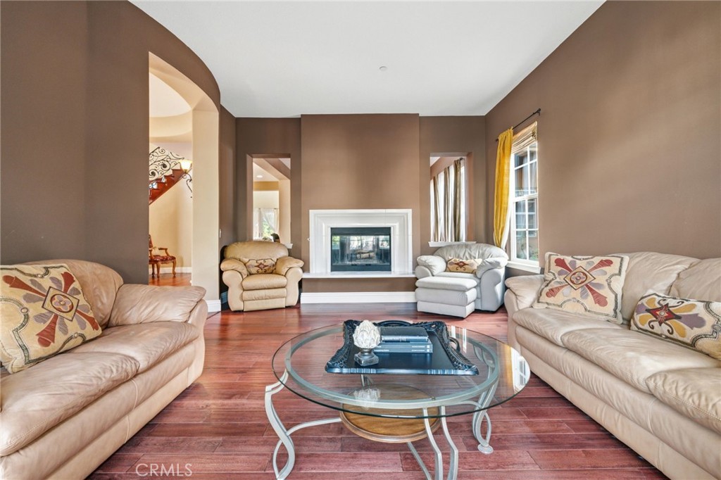 4463 Cardinal Cushing Claremont, CA 91711 - Photo 12 of 75 a living room with furniture couches and a fireplace