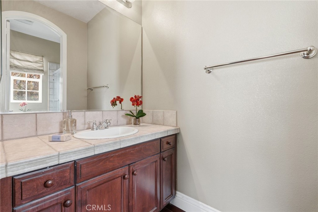 4463 Cardinal Cushing Claremont, CA 91711 - Photo 37 of 75 a bathroom with a granite countertop sink and a mirror