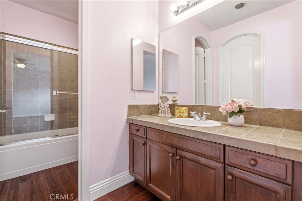 4463 Cardinal Cushing Claremont, CA 91711 - Photo 46 of 75 a bathroom with a granite countertop sink and a mirror