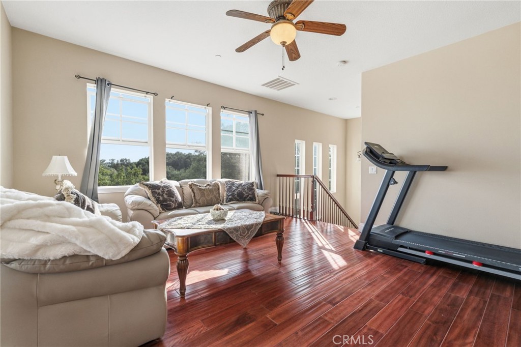 4463 Cardinal Cushing Claremont, CA 91711 - Photo 62 of 75 a living room with furniture gym equipment and a large window