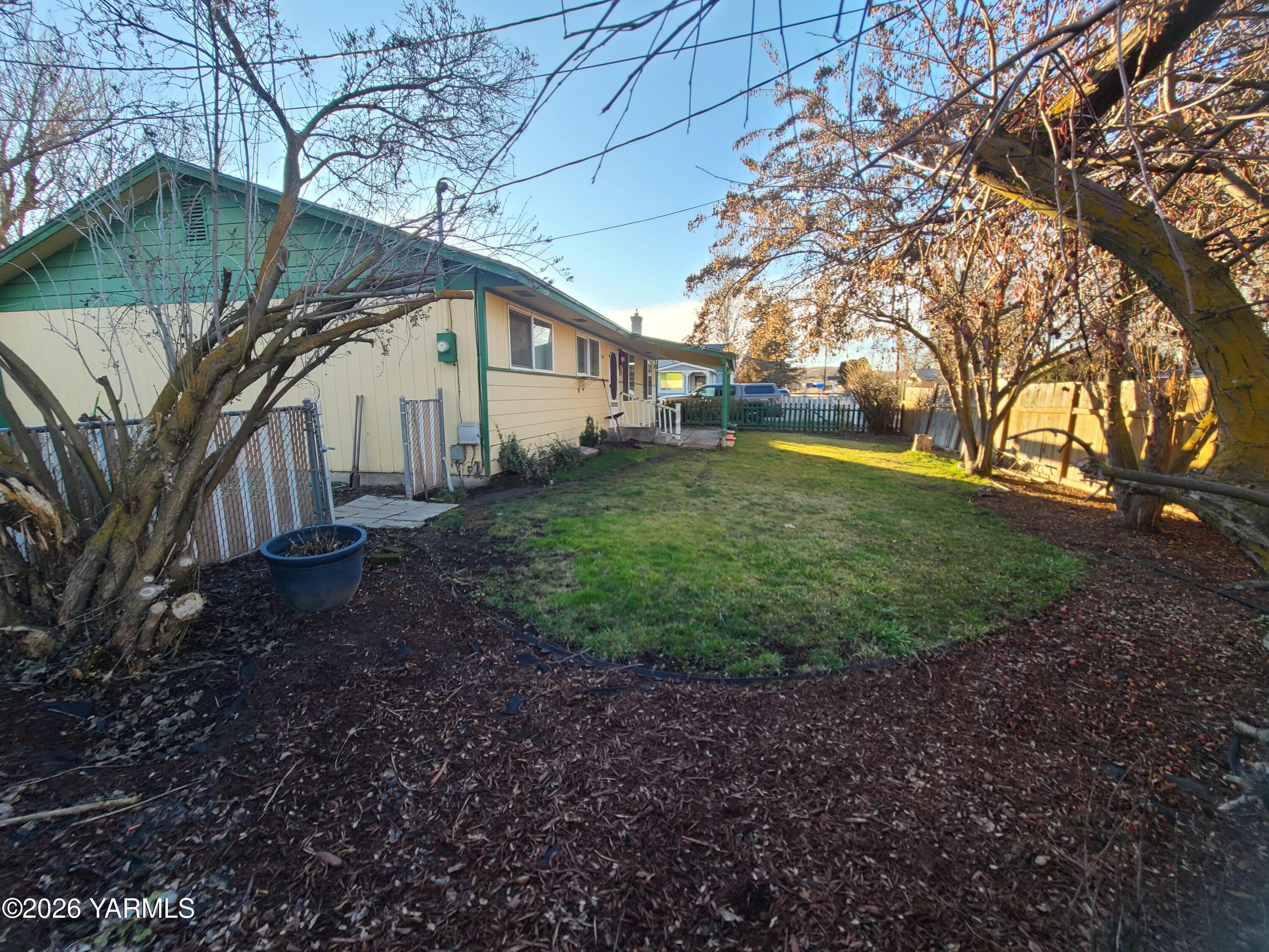 10608 Hackett Road Yakima, WA 98903 - Photo 3 of 25 a view of a big house with a big yard and large tree