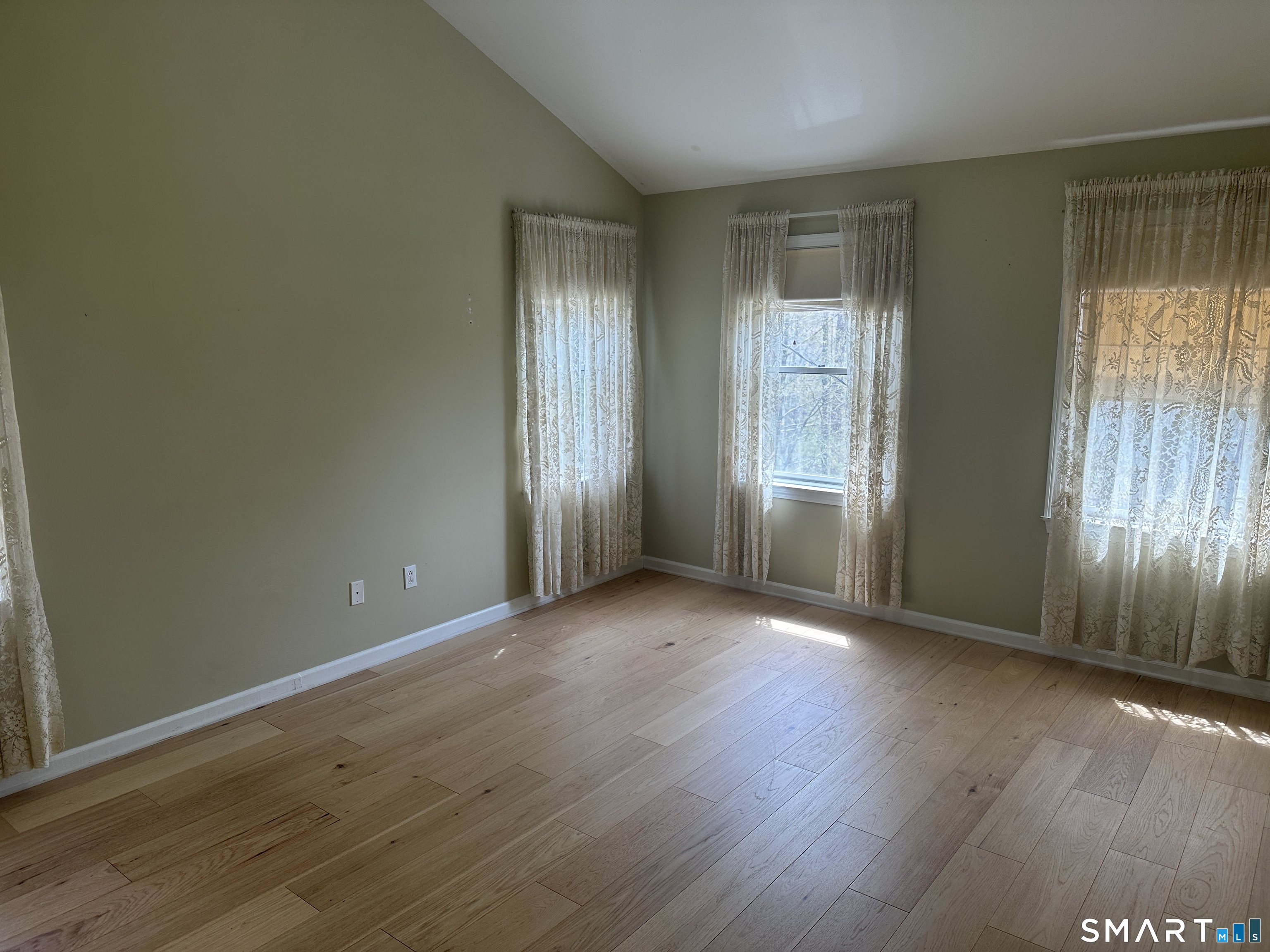 181 North Chestnut Hill Road Killingworth, CT 06419 - Photo 16 of 26 an empty room with wooden floor and windows
