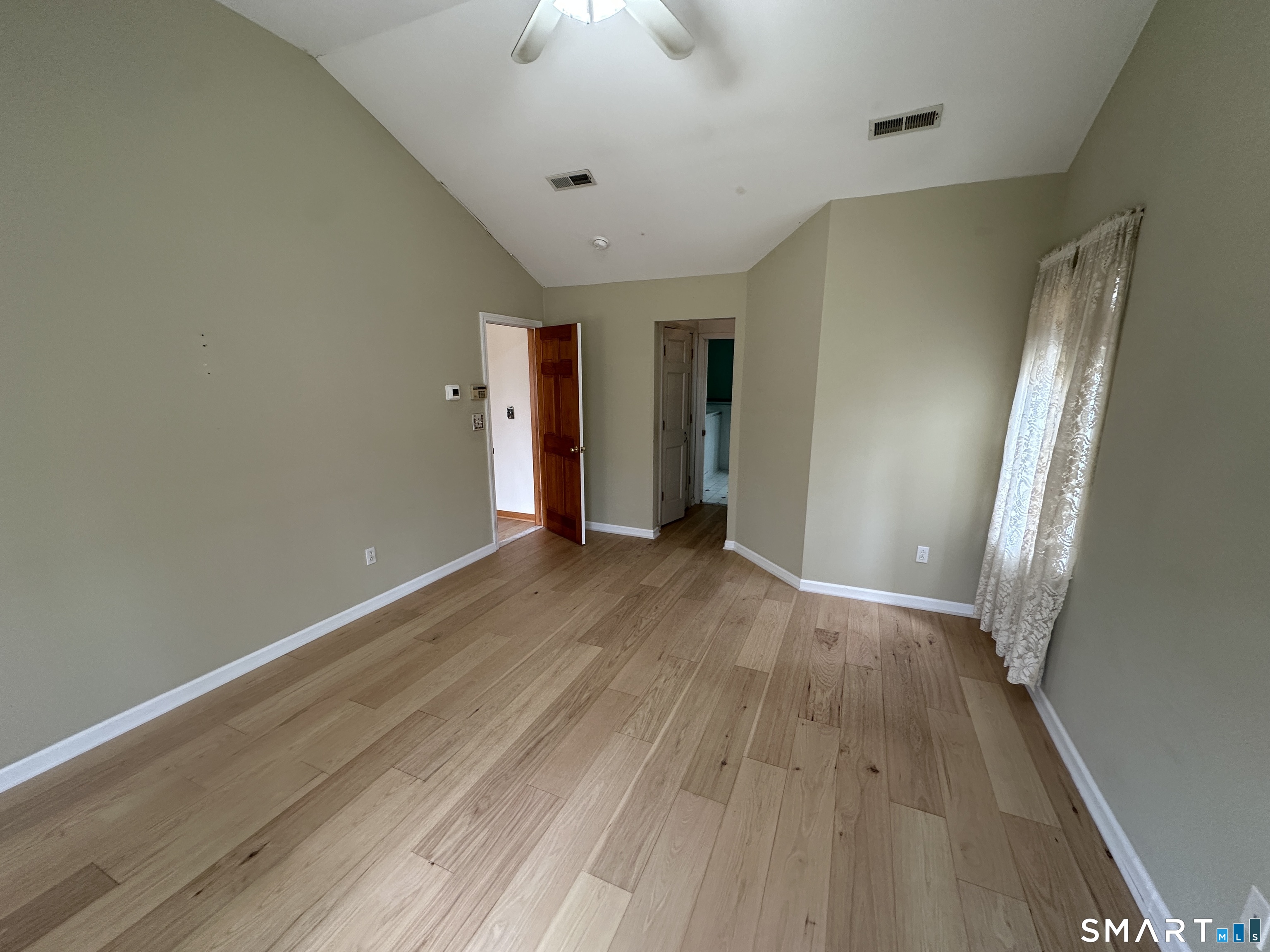 181 North Chestnut Hill Road Killingworth, CT 06419 - Photo 22 of 26 an empty room with wooden floor and windows