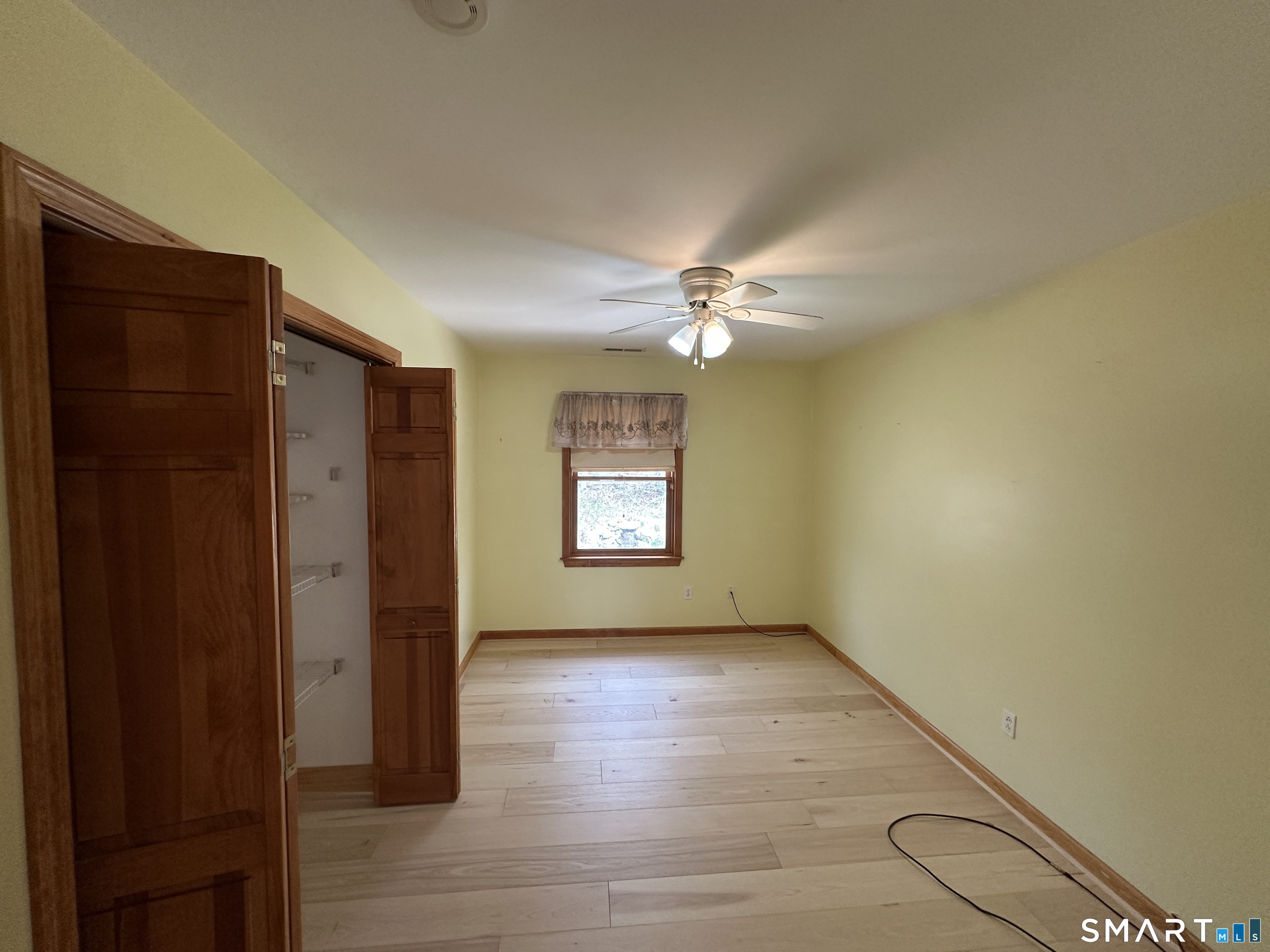 181 North Chestnut Hill Road Killingworth, CT 06419 - Photo 23 of 26 a view of an empty room with wooden floor and fan