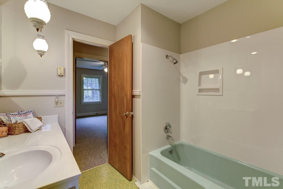 716 Sheriff Johnson Road Coats, NC 27521 - Photo 11 of 25 a bathroom with a tub and shower