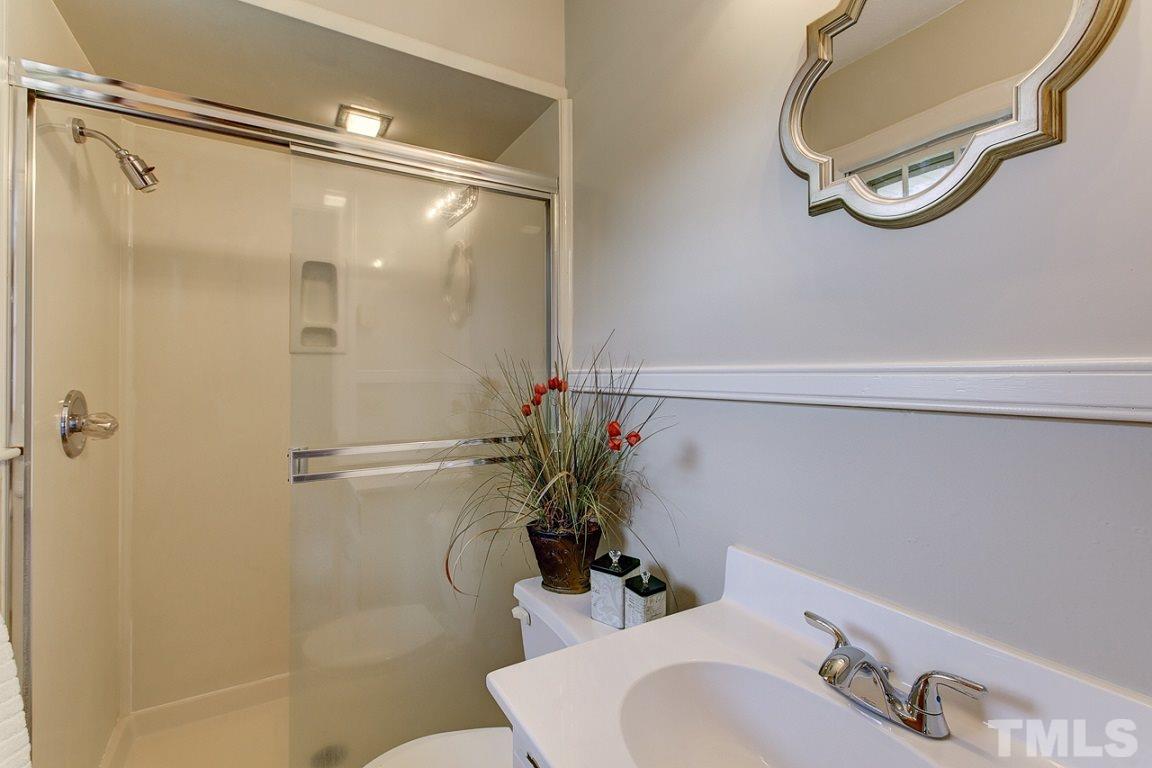 716 Sheriff Johnson Road Coats, NC 27521 - Photo 14 of 25 a bathroom with a sink vanity mirror and toilet