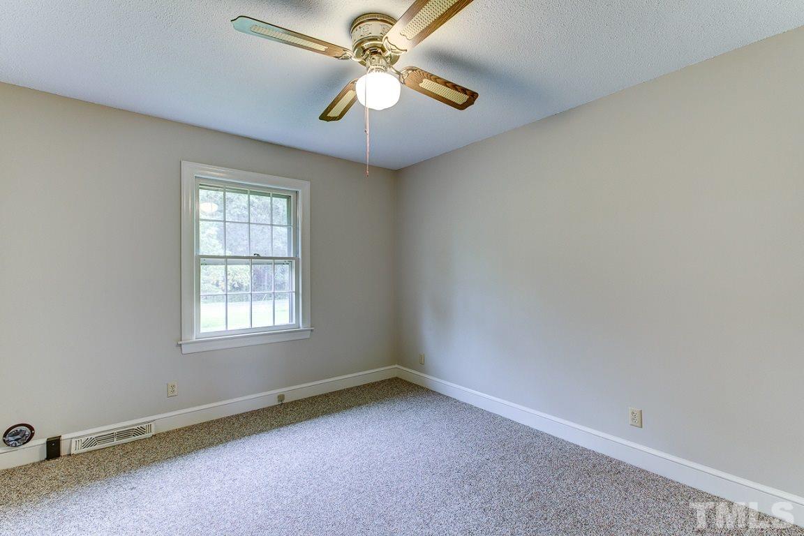 716 Sheriff Johnson Road Coats, NC 27521 - Photo 17 of 25 an empty room with windows and fan