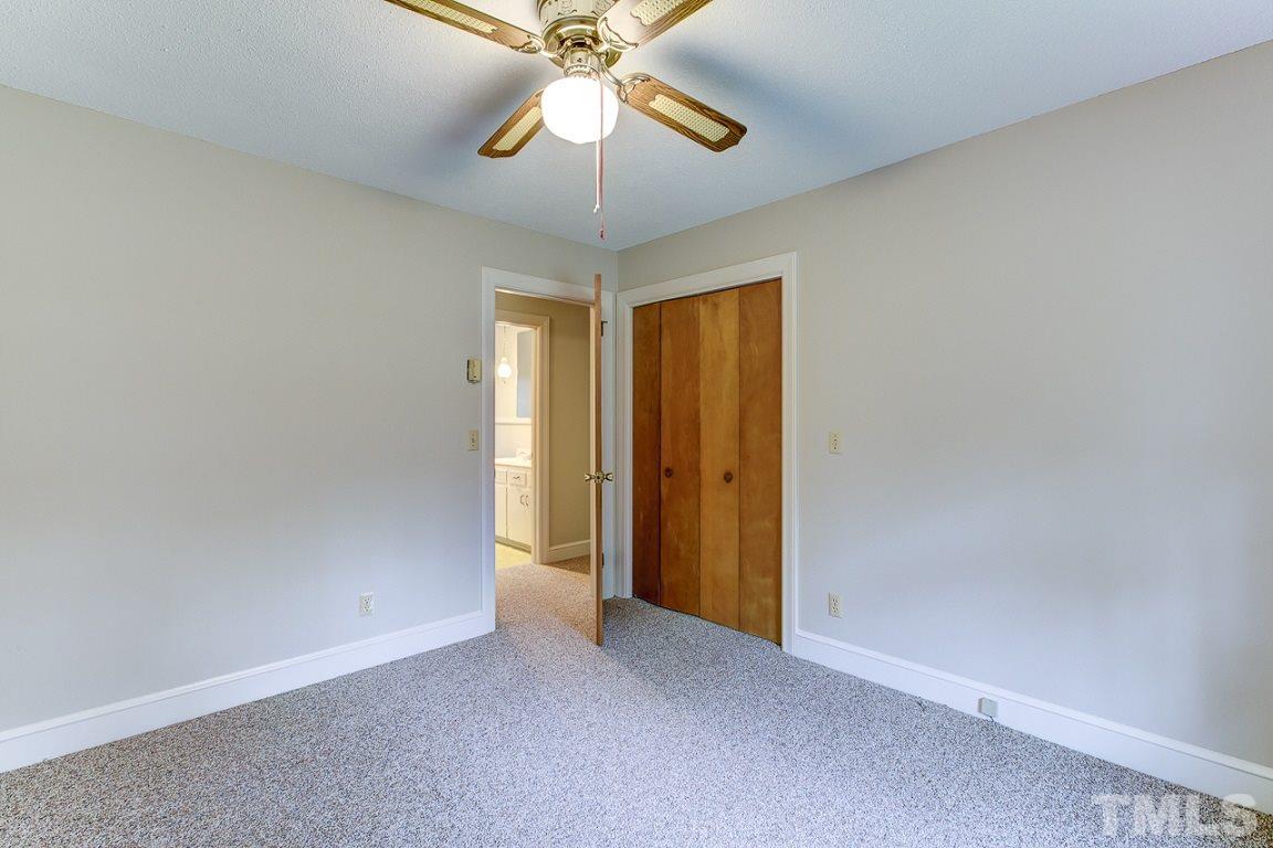 716 Sheriff Johnson Road Coats, NC 27521 - Photo 18 of 25 an empty room with a chandelier fan and a chandelier fan