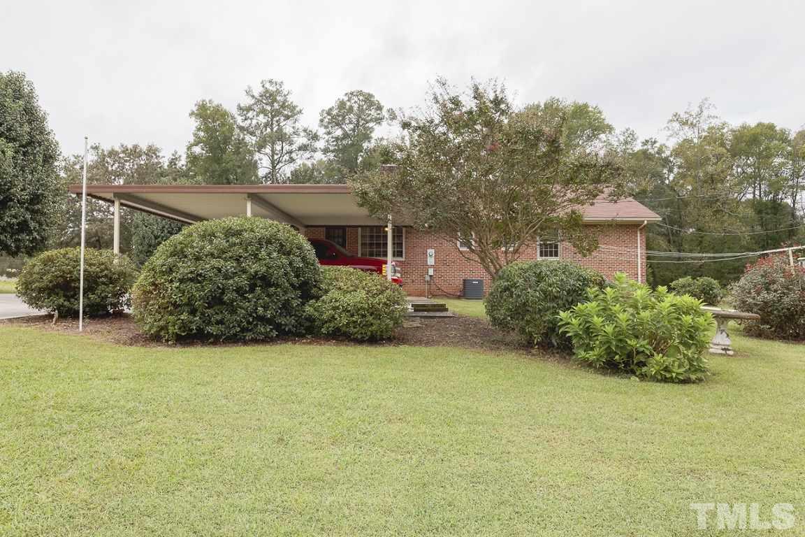 716 Sheriff Johnson Road Coats, NC 27521 - Photo 24 of 25 a view of a house with backyard and garden