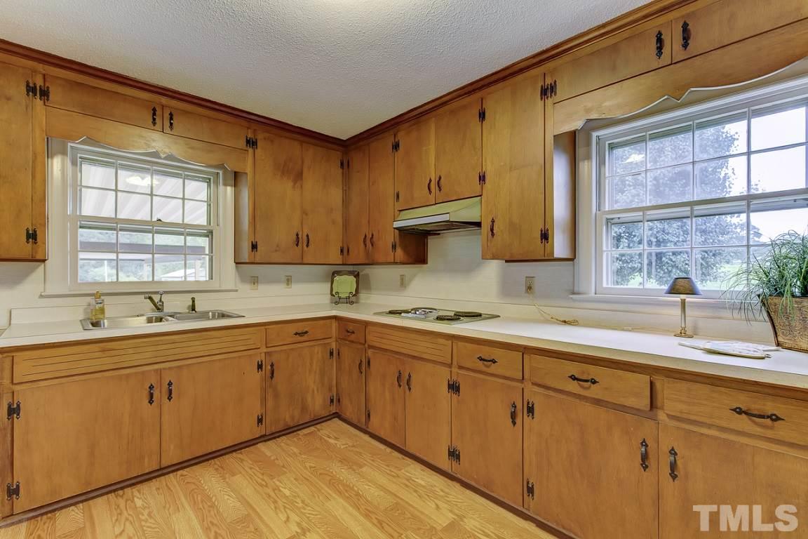 716 Sheriff Johnson Road Coats, NC 27521 - Photo 8 of 25 a kitchen with sink cabinets and window